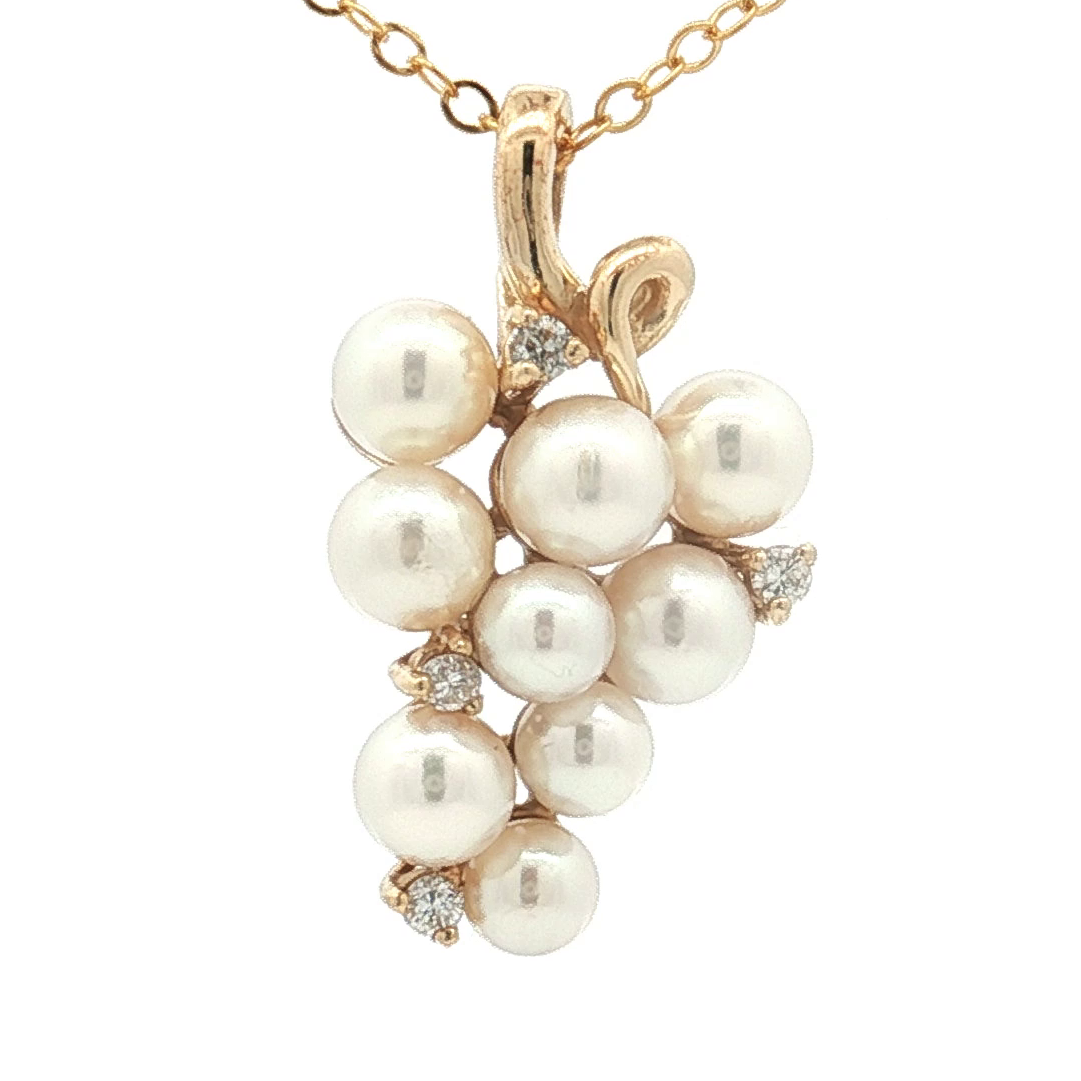 Pearl necklace with gold chain on a white background