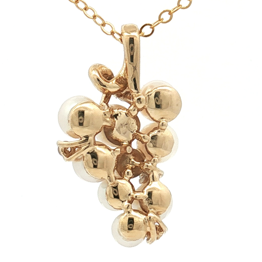 Gold necklace with a cluster pendant on a white background