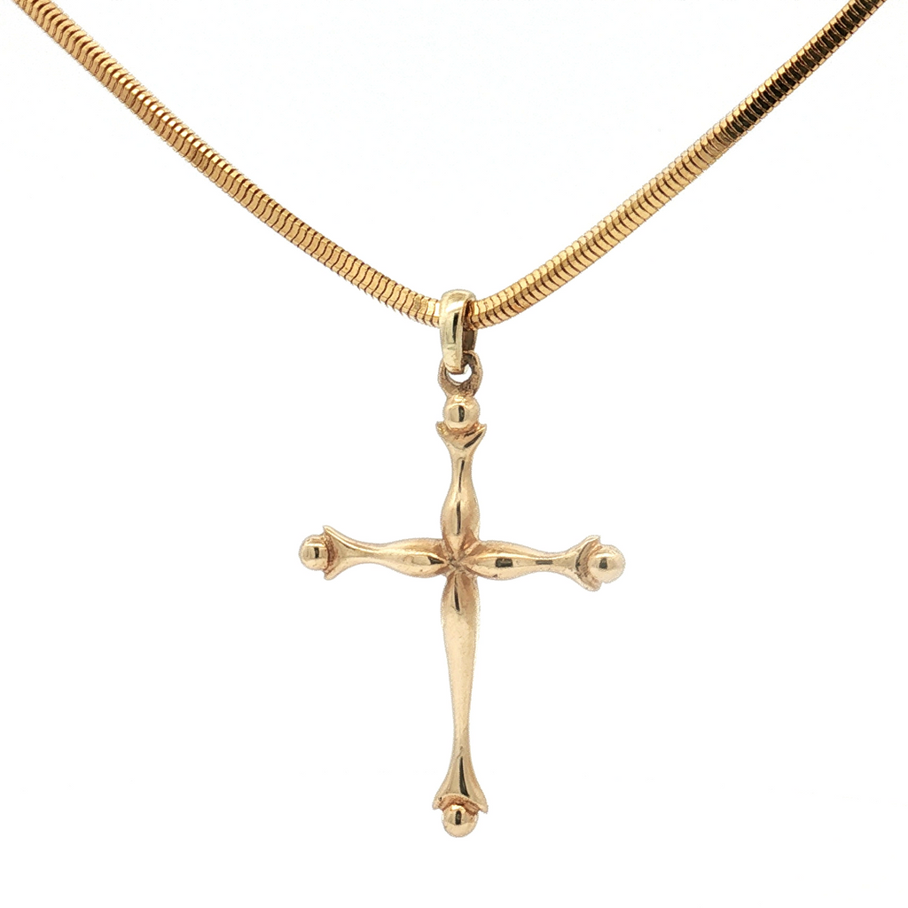 Gold cross pendant on a gold chain against a white background