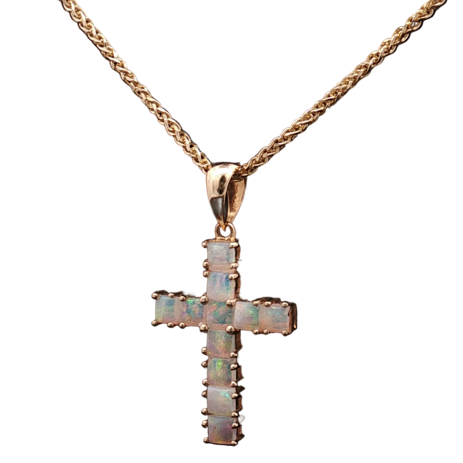 Gold cross pendant necklace on a white background